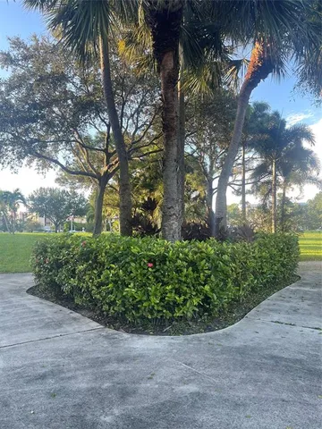 a sign board with tall trees
