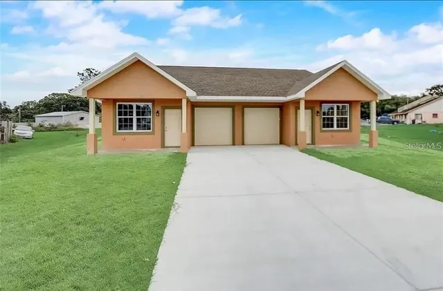 a front view of house with yard and green space