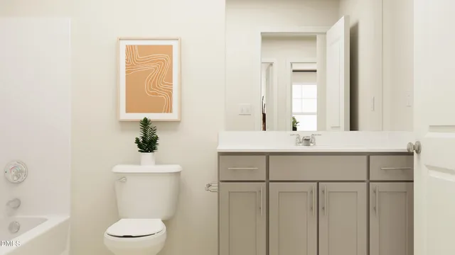 a bed sitting in a bedroom next to a lamp next to a window