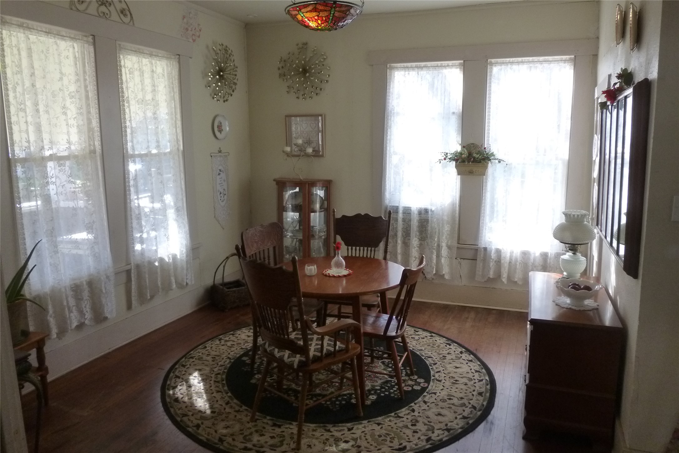 502 West 10th Street Taylor, TX 76574 - Photo 14 of 34 a view of a dining room with furniture window and wooden floor