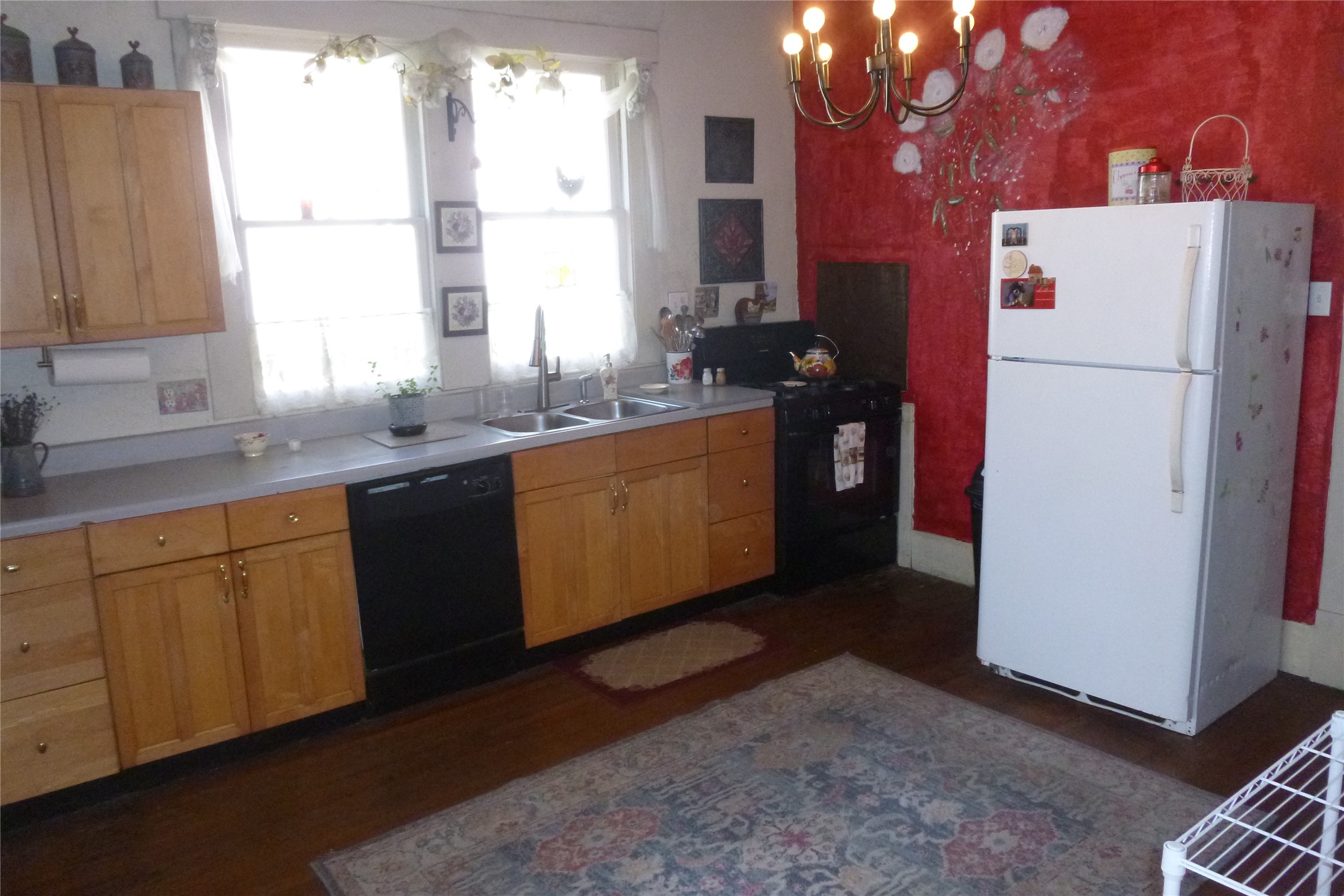 502 West 10th Street Taylor, TX 76574 - Photo 16 of 34 a kitchen with stainless steel appliances granite countertop a refrigerator a sink a stove a microwave and cabinets