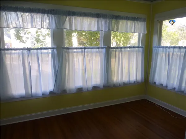 a living room with furniture rug and window