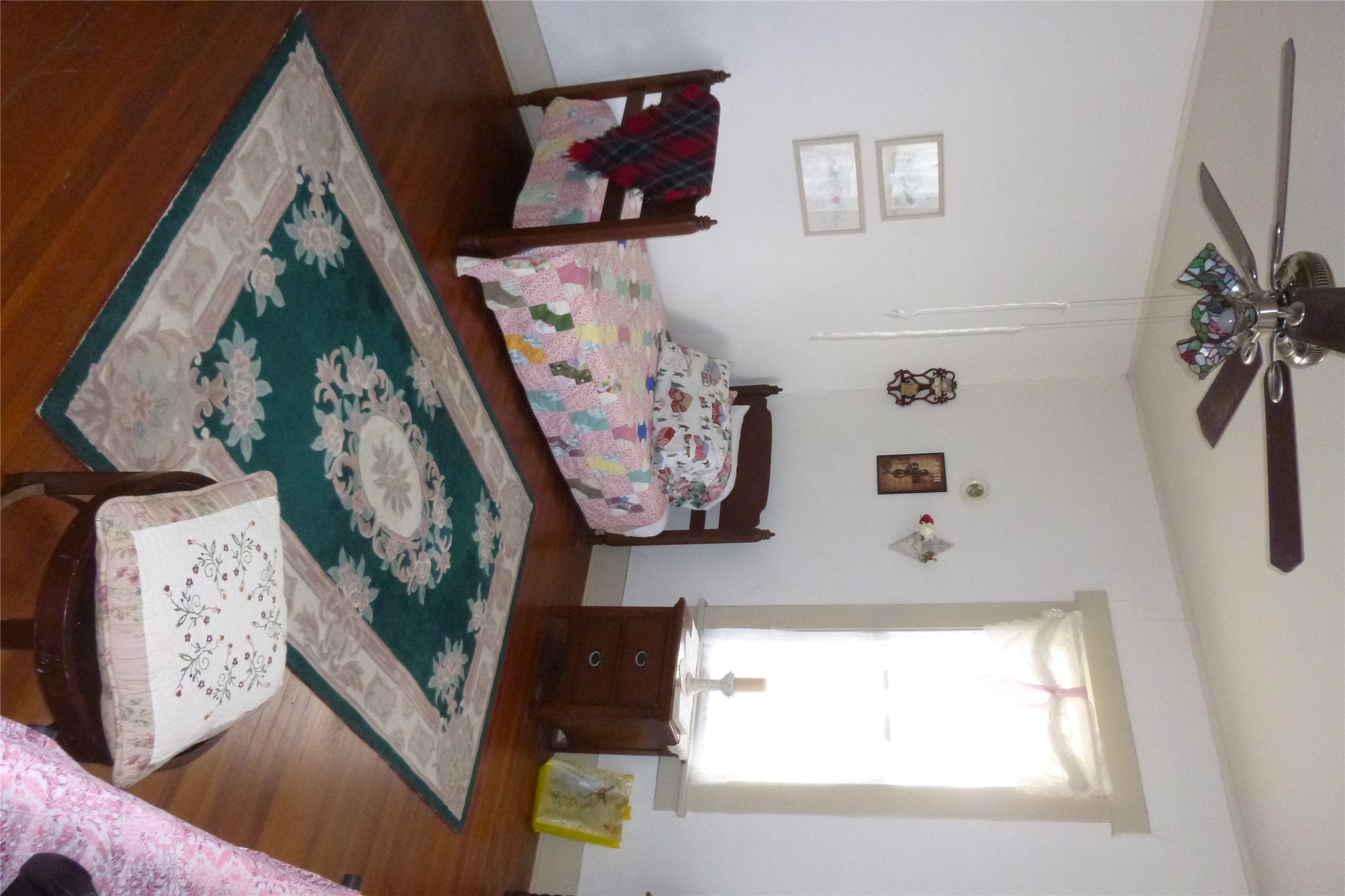 502 West 10th Street Taylor, TX 76574 - Photo 26 of 34 a bed sitting in a bedroom next to a window with a dresser