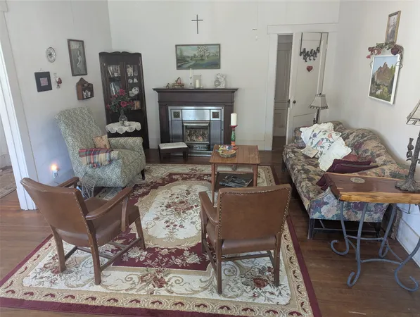 a living room with furniture a rug and a window