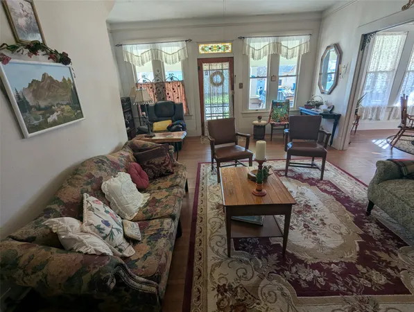a living room with furniture and a floor to ceiling window