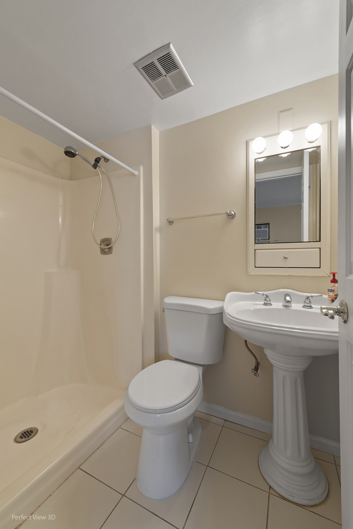 7305 Tiffany Drive, Unit 1A Orland Park, IL 60462 - Photo 13 of 20 a bathroom with a sink a toilet and shower