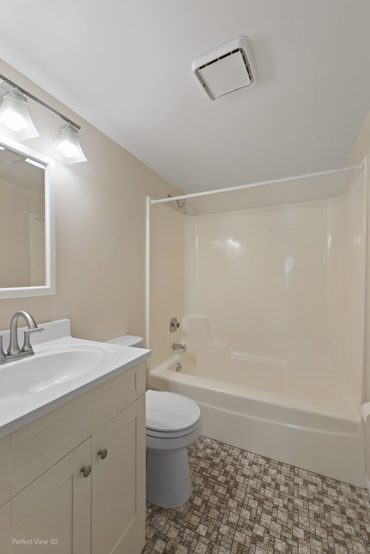 7305 Tiffany Drive, Unit 1A Orland Park, IL 60462 - Photo 17 of 20 a bathroom with a sink a toilet and shower