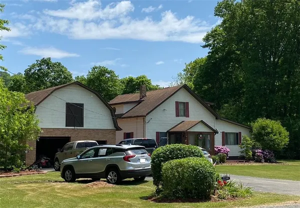 a car parked in front of a house with a yard