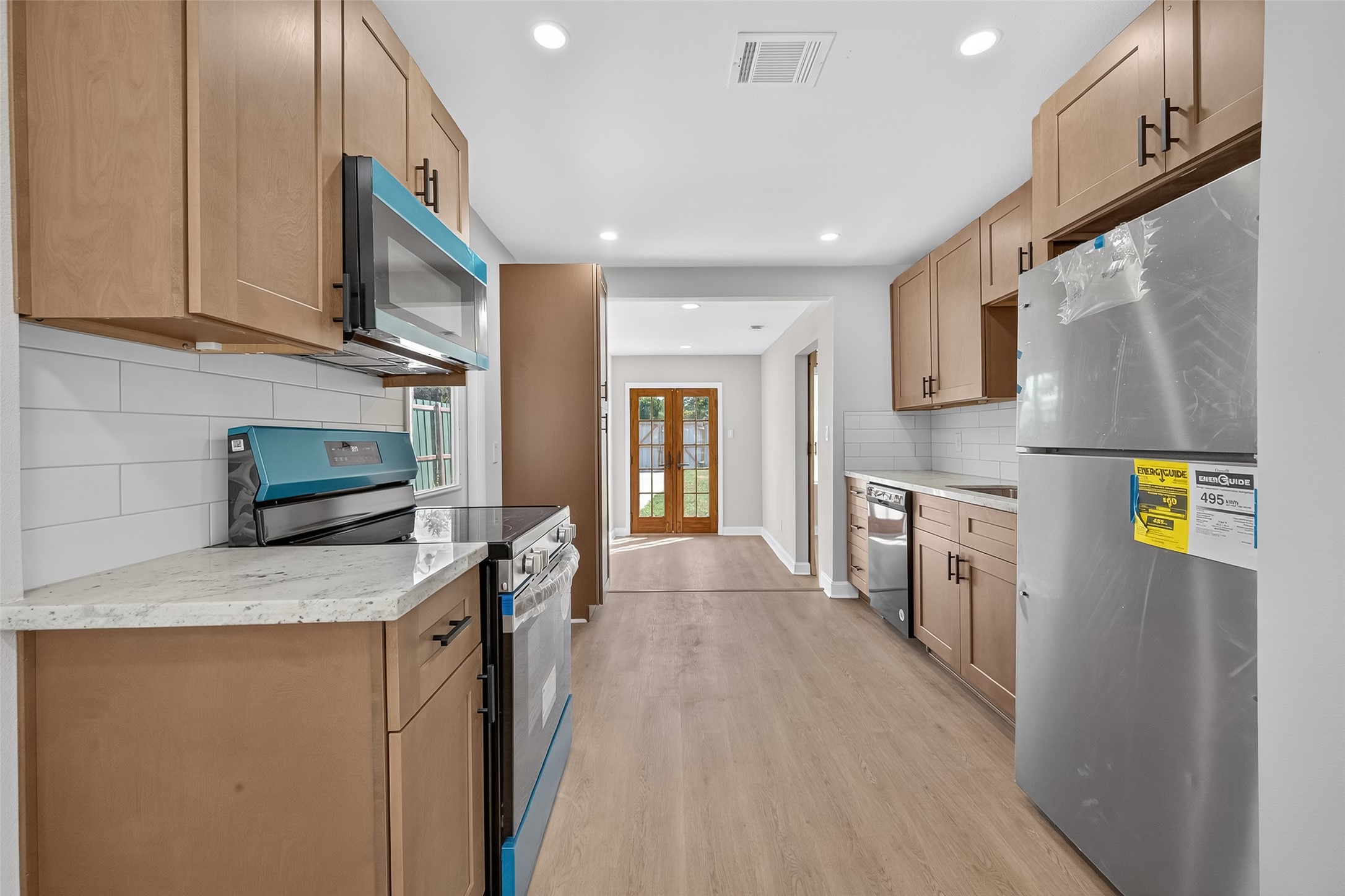 889 Chas Lane Houston, TX 77091 - Photo 7 of 32 a kitchen with stainless steel appliances granite countertop a refrigerator a stove top oven a sink and dishwasher