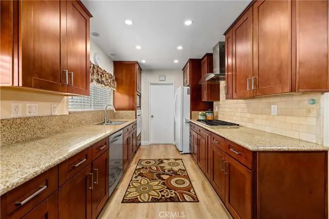 a large kitchen with stainless steel appliances granite countertop plenty wooden cabinets and granite counter tops