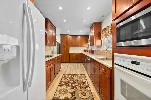 a view of a kitchen with a sink and wooden floor