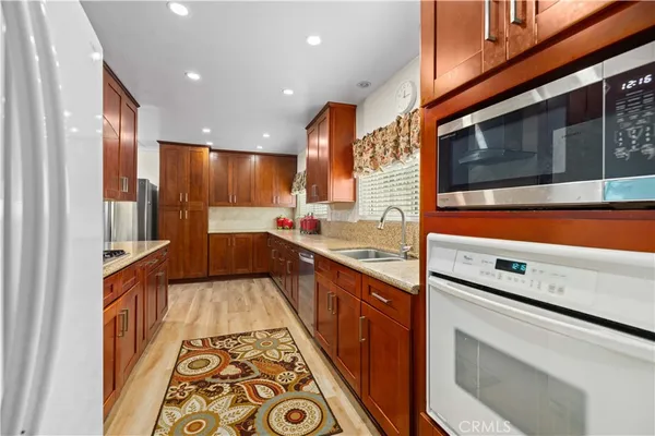 a kitchen with stainless steel appliances a stove and a sink
