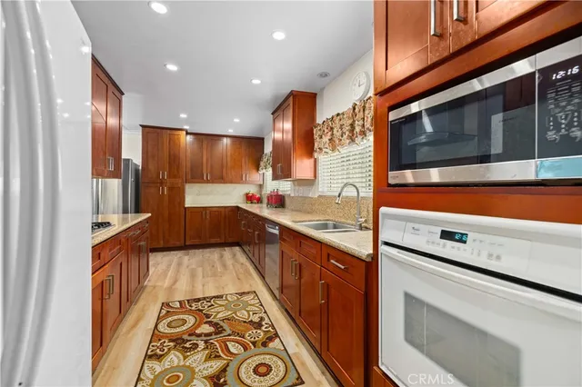 a kitchen with stainless steel appliances a stove and a sink