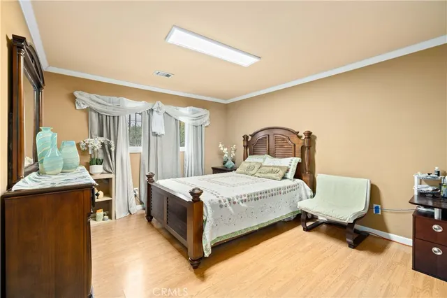 a bedroom with a bed table and chair