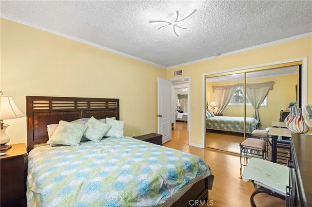 a bedroom with a bed and wooden floor