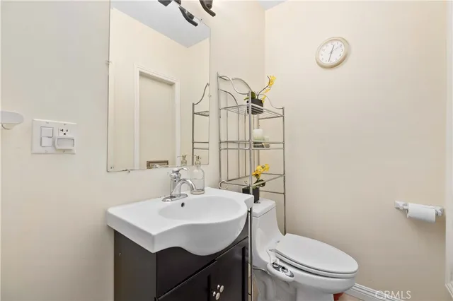 a bathroom with a sink a toilet and mirror