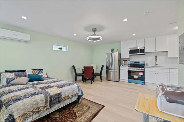 a bedroom with a bed a table and chairs