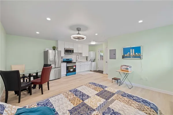 a living room with furniture and kitchen view