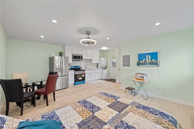 a living room with furniture and kitchen view