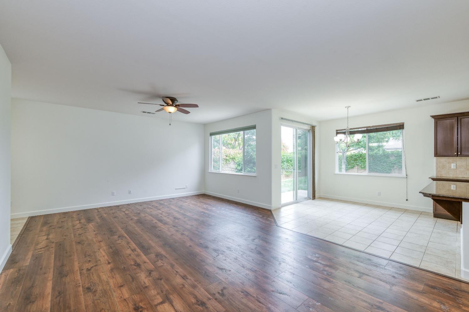 1697 North Connery Lane Clovis, CA 93619 - Photo 11 of 56 wooden floor in an empty room with a window
