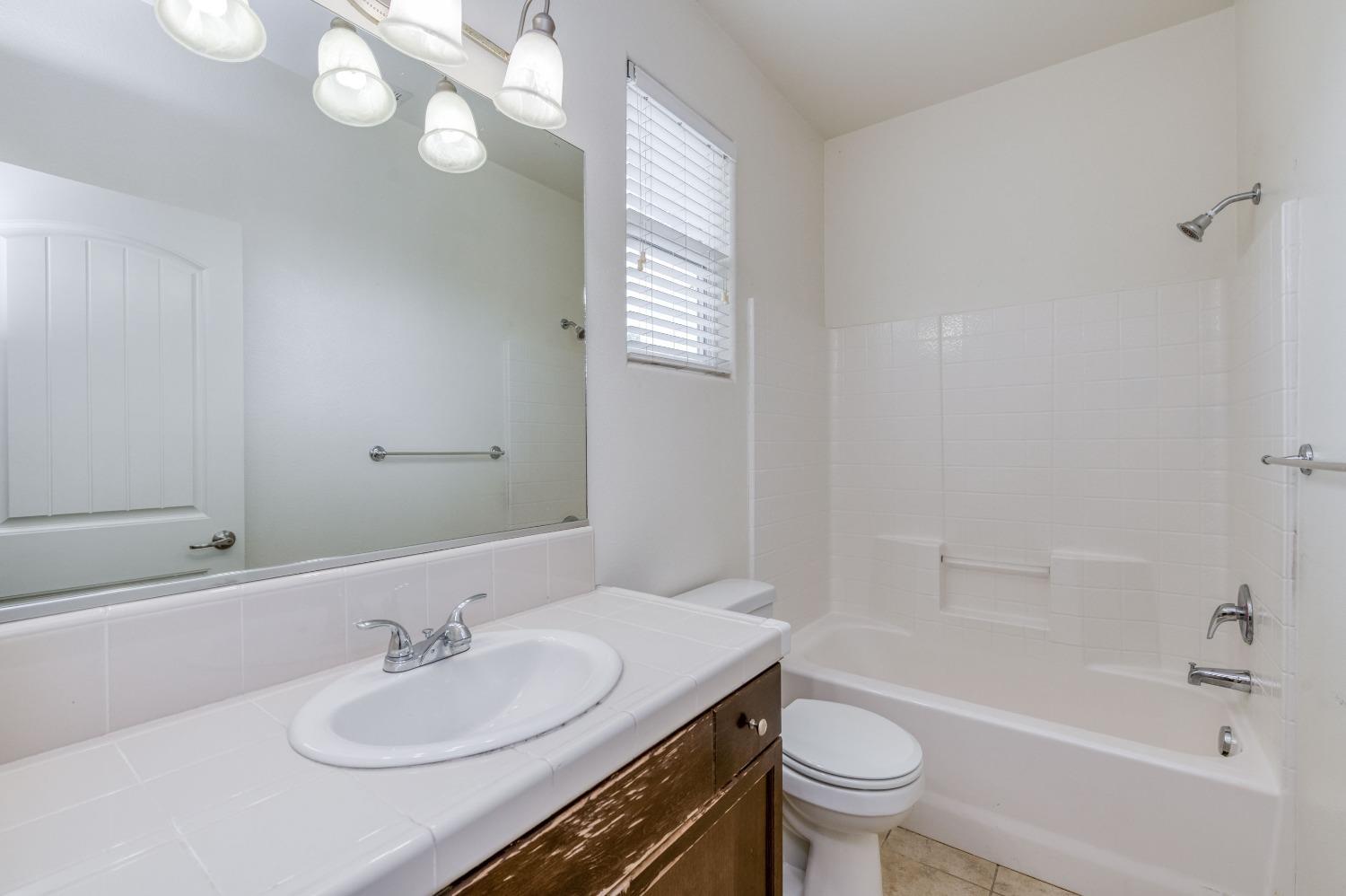 1697 North Connery Lane Clovis, CA 93619 - Photo 20 of 56 a bathroom with a sink toilet tub and vanity