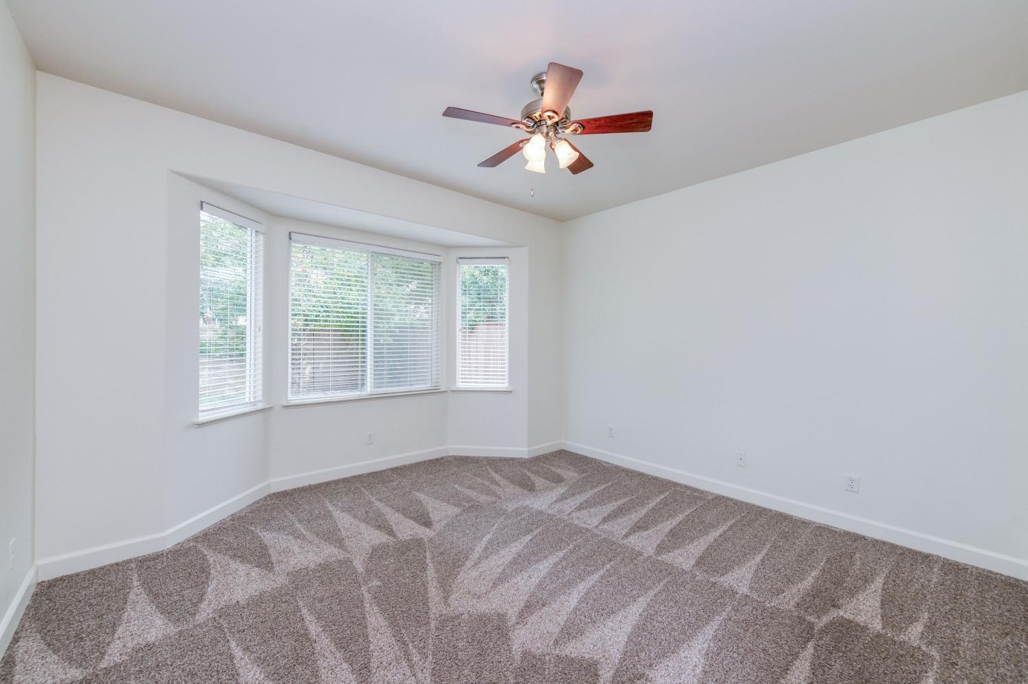 1697 North Connery Lane Clovis, CA 93619 - Photo 21 of 56 a view of a livingroom with a ceiling fan and window