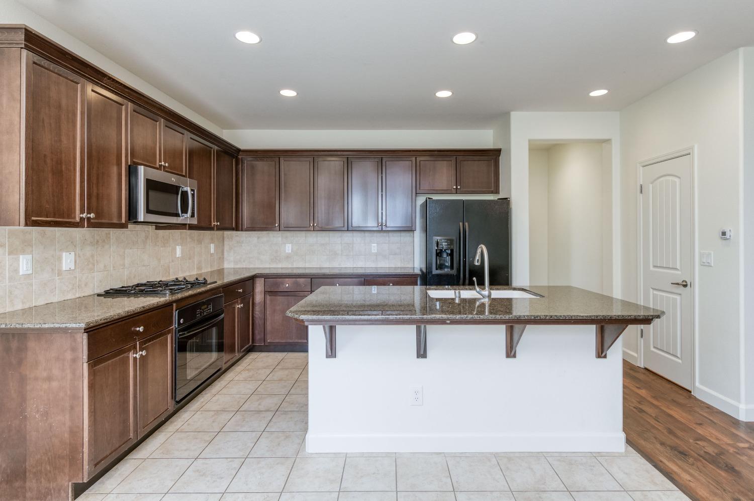 1697 North Connery Lane Clovis, CA 93619 - Photo 3 of 56 a kitchen with a sink and cabinets