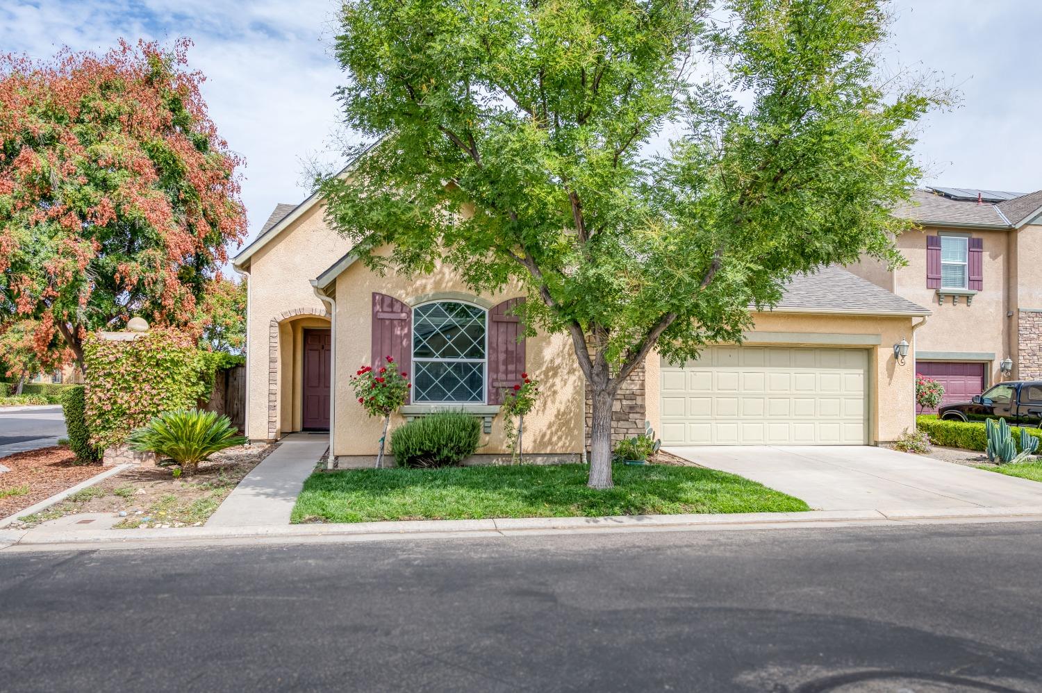 1697 North Connery Lane Clovis, CA 93619 - Photo 53 of 56 a front view of a house with a yard and a garage