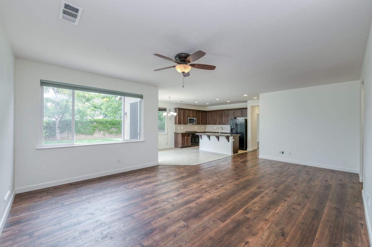 1697 North Connery Lane Clovis, CA 93619 - Photo 8 of 56 wooden floor in an empty room with a window