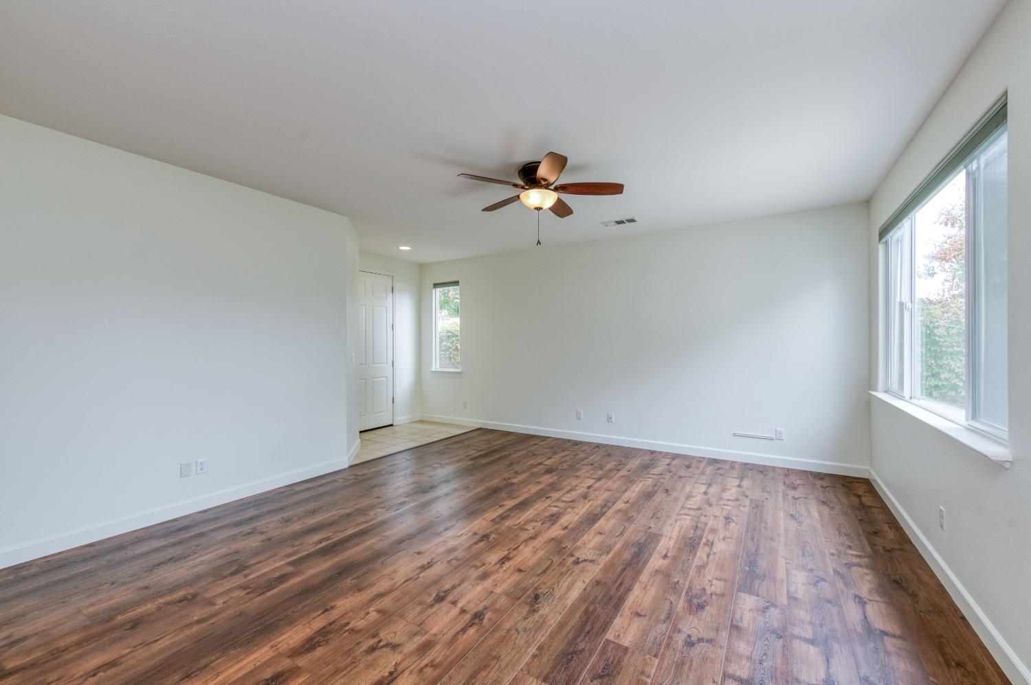 1697 North Connery Lane Clovis, CA 93619 - Photo 10 of 56 wooden floor in an empty room with a window