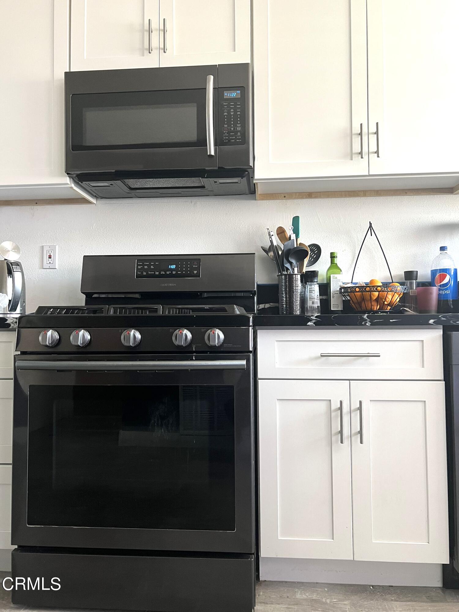 511 East Bard Road, Unit 16 Oxnard, CA 93033 - Photo 9 of 13 a kitchen with a stove and a microwave