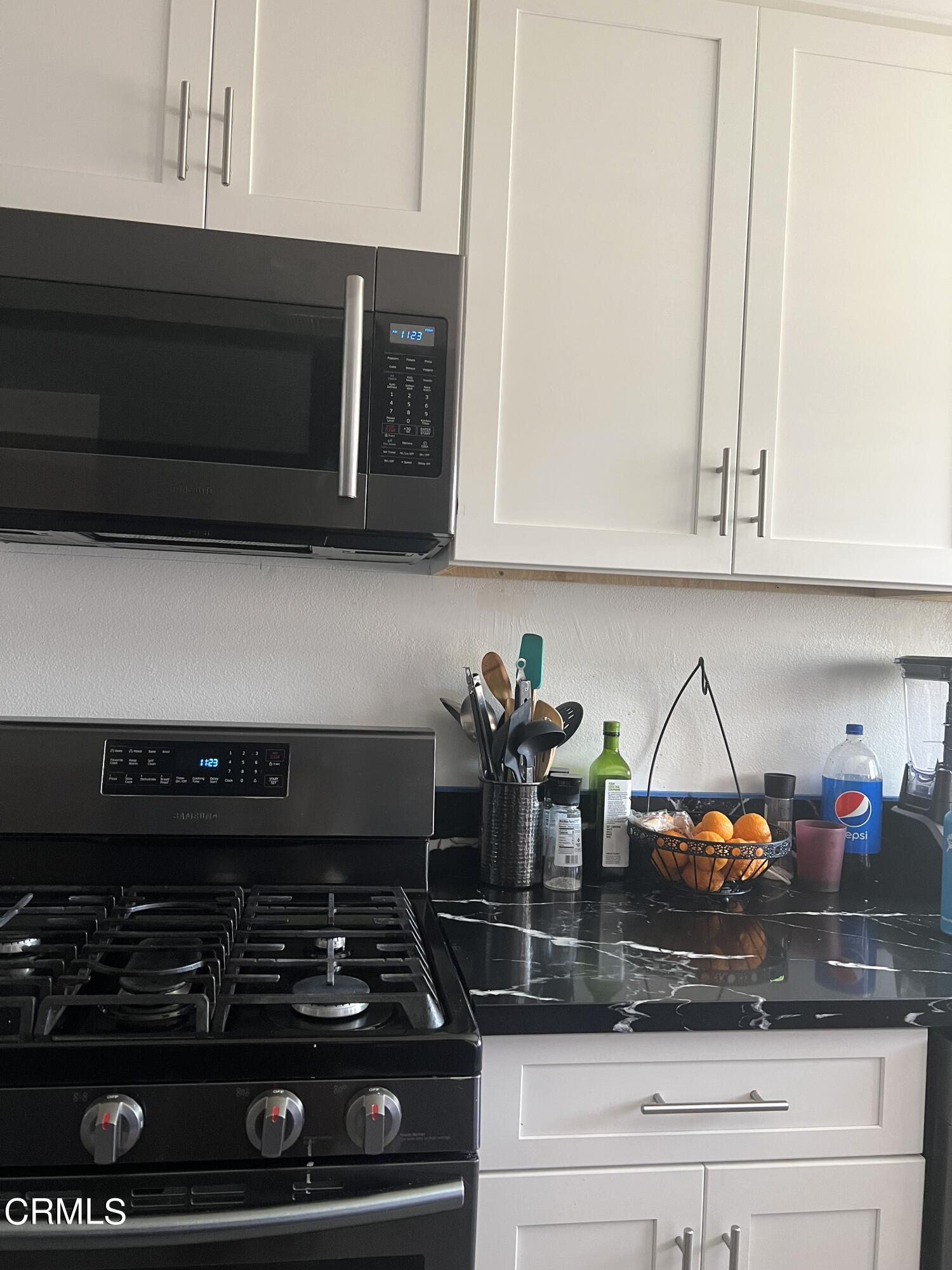 511 East Bard Road, Unit 16 Oxnard, CA 93033 - Photo 10 of 13 a kitchen with a stove and cabinets