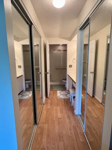 a view of a hallway view with wooden floor and staircase