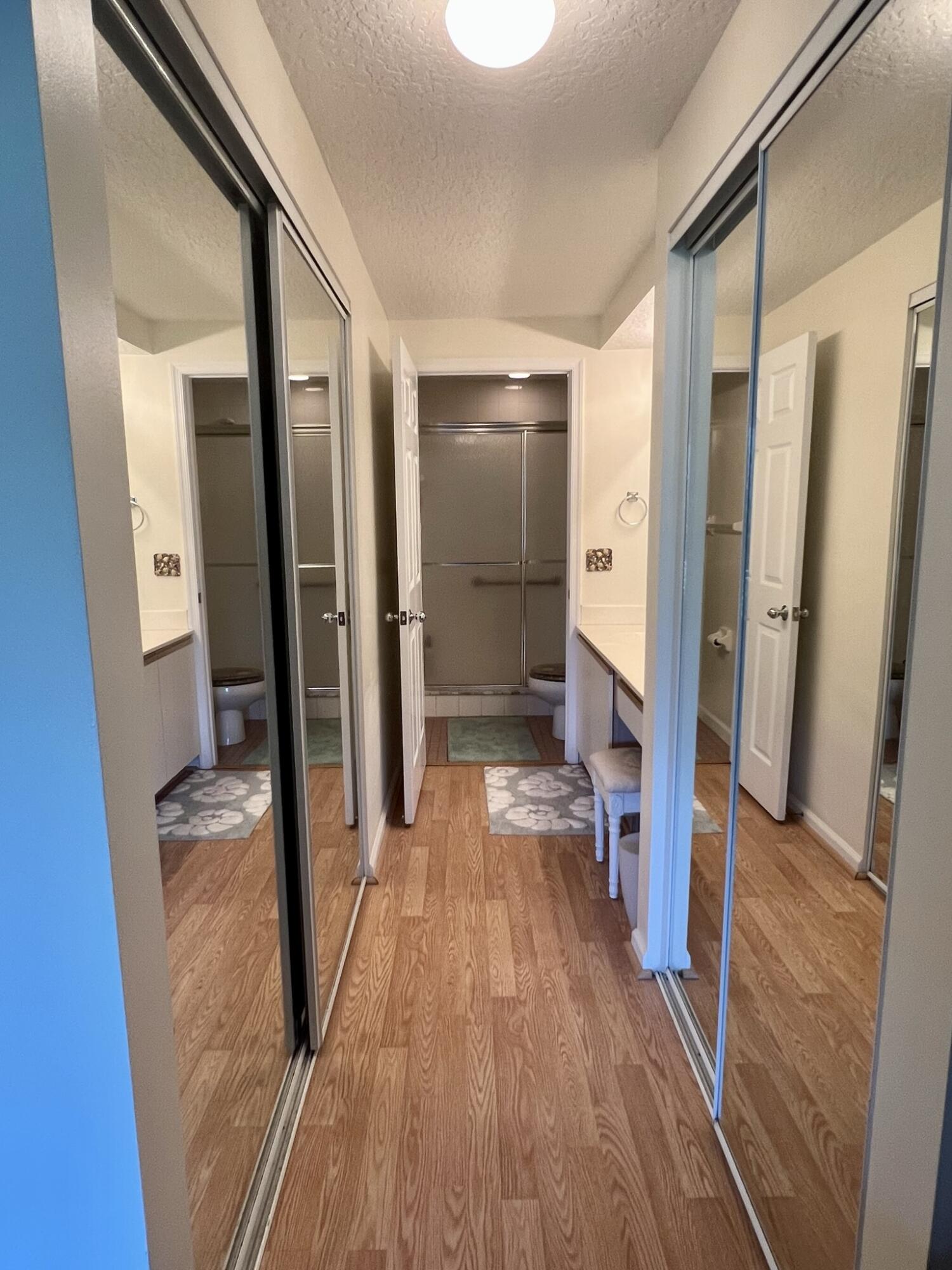 101 Muirfield Court, Unit F Jupiter, FL 33458 - Photo 14 of 20 a view of a hallway view with wooden floor and staircase
