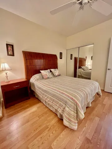 a bedroom with a bed and a lamp on the dresser