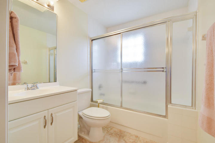 101 Muirfield Court, Unit F Jupiter, FL 33458 - Photo 18 of 20 a bathroom with a sink a toilet and shower