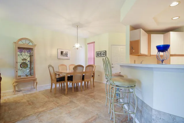 a dining room with furniture and window