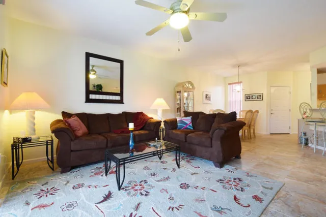 a living room with furniture and a chandelier
