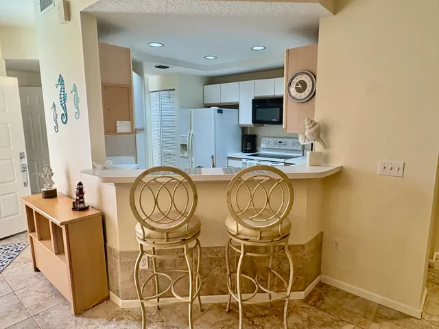 a view of a kitchen with stainless steel appliances granite countertop a stove and a sink