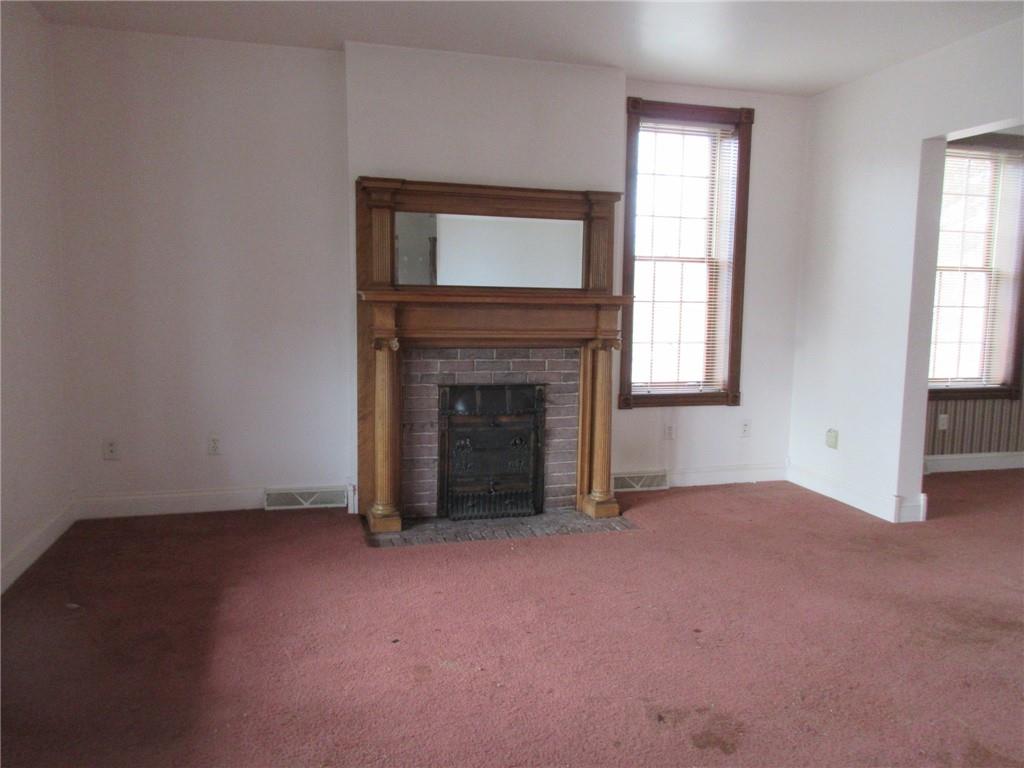 809 Thomas Street Monongahela, PA 15063 - Photo 4 of 11 an empty room with windows and fireplace