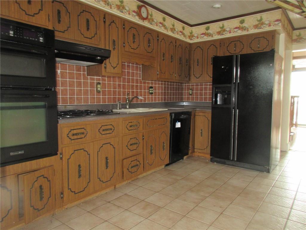 809 Thomas Street Monongahela, PA 15063 - Photo 7 of 11 a kitchen with stainless steel appliances granite countertop a stove and cabinets