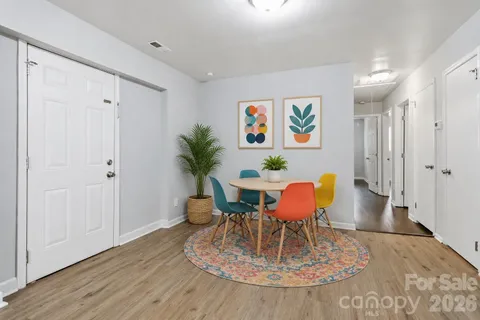 a dining room with furniture a rug and wooden floor