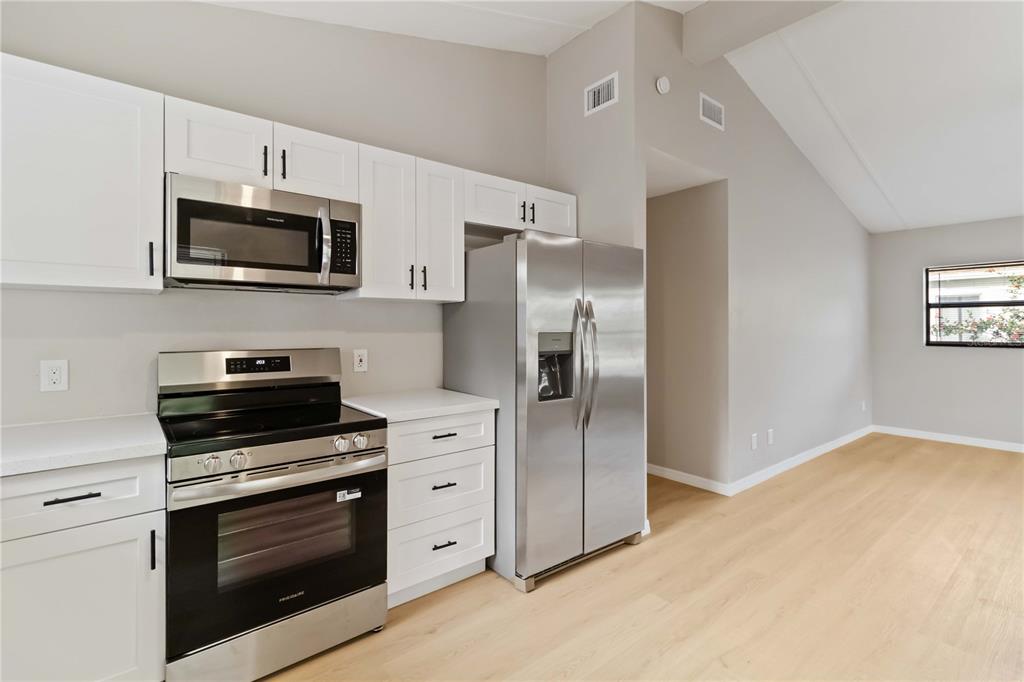 1368 21st Street Sarasota, FL 34234 - Photo 12 of 34 a kitchen with stainless steel appliances white cabinets and a stove top oven
