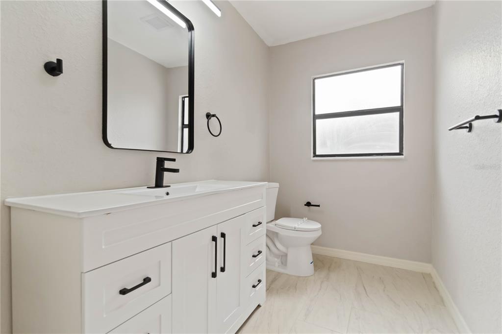 1368 21st Street Sarasota, FL 34234 - Photo 18 of 34 a bathroom with a toilet sink and mirror