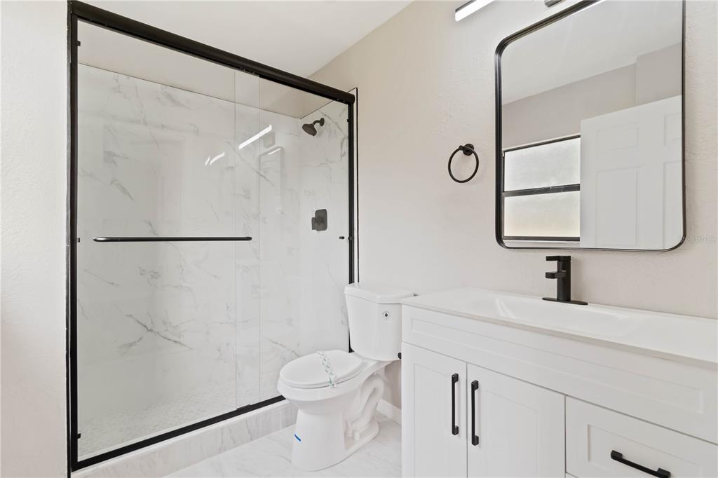 1368 21st Street Sarasota, FL 34234 - Photo 28 of 34 a bathroom with a toilet sink and a mirror