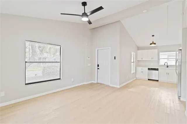a kitchen with a refrigerator sink and cabinets