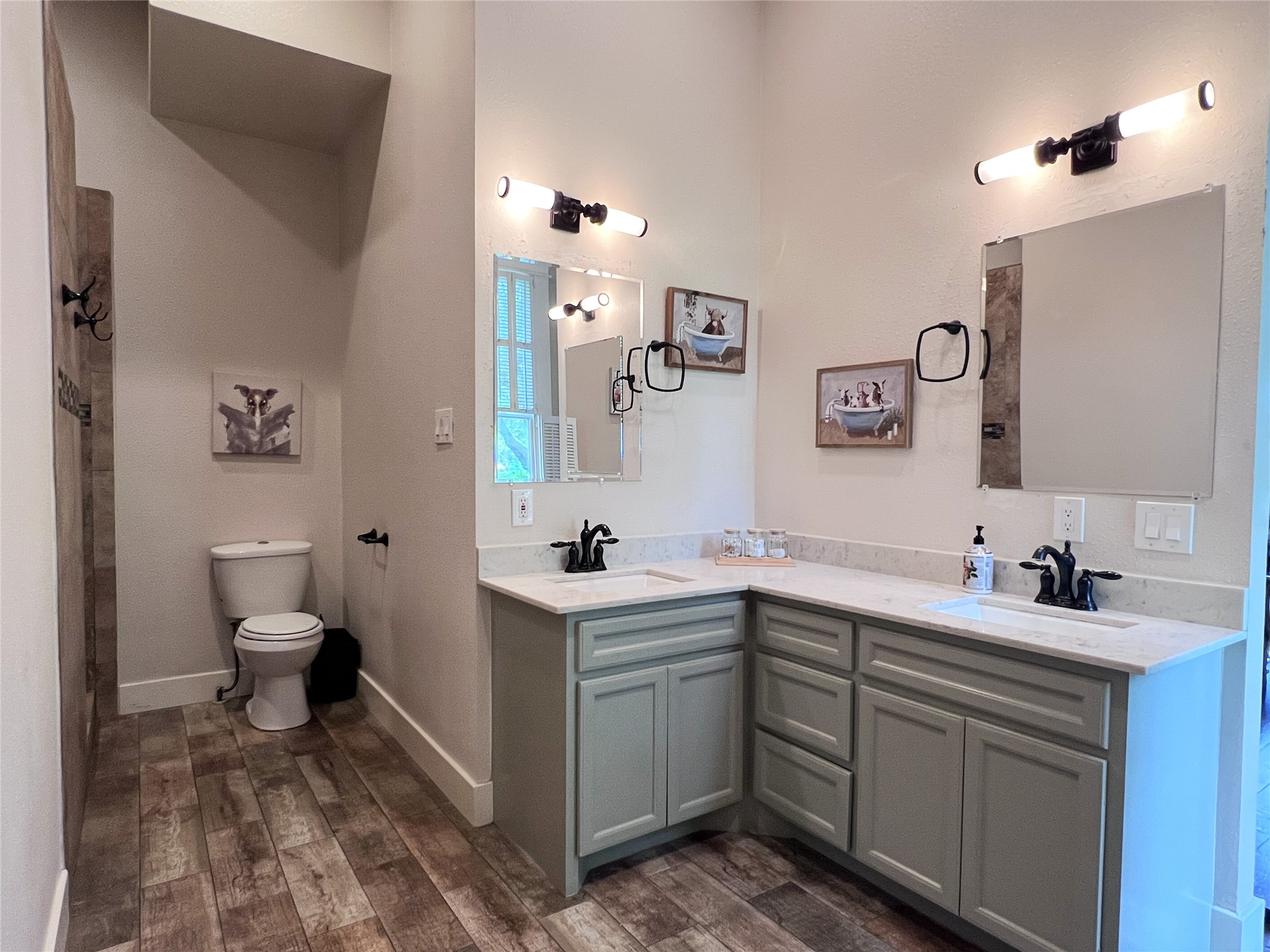 606 Sycamore Street Brenham, TX 77833 - Photo 11 of 27 a bathroom with a toilet sink and mirror