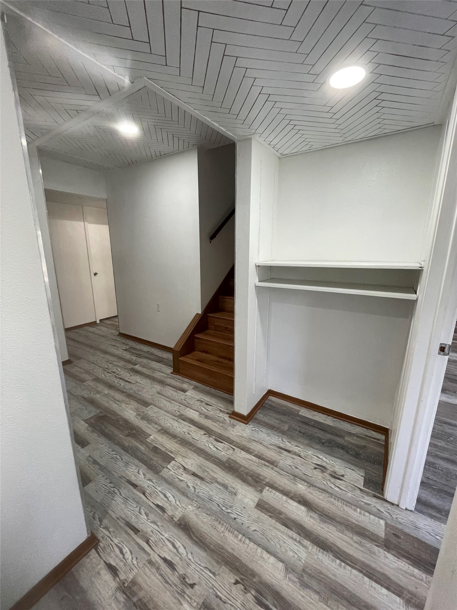 5802 Longhorn Landing Austin, TX 78734 - Photo 25 of 38 Basement with light wood-style flooring and stairs