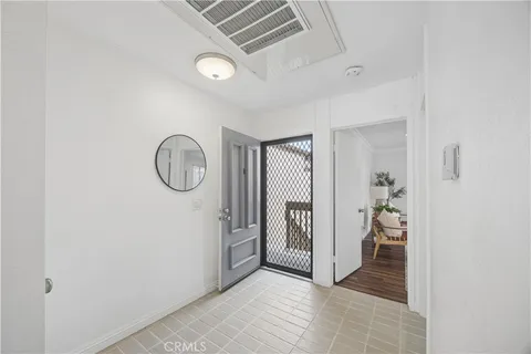 a view of a hallway to rooms