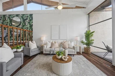a living room with furniture and a potted plant